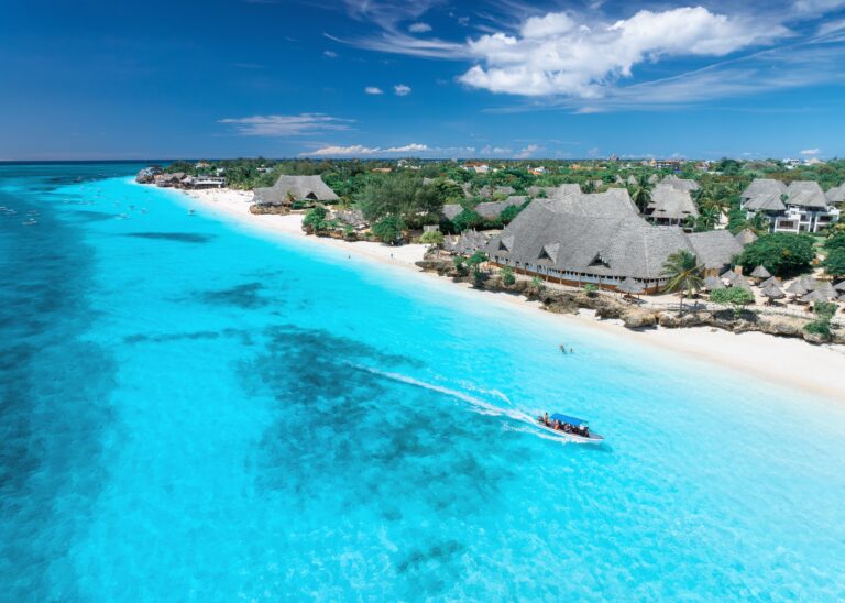 Aerial,View,Of,Sandy,Beach,,Blue,Sea,,Bungalows,,Green,Palms,
